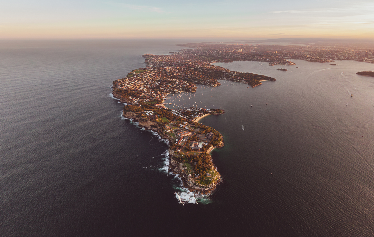 XXL panoramic sunset aerial drone view looking south to South Head, a headland & part of Sydney Harbour National Park, to the north of the suburb of Watsons Bay in Sydney, New South Wales, Australia.